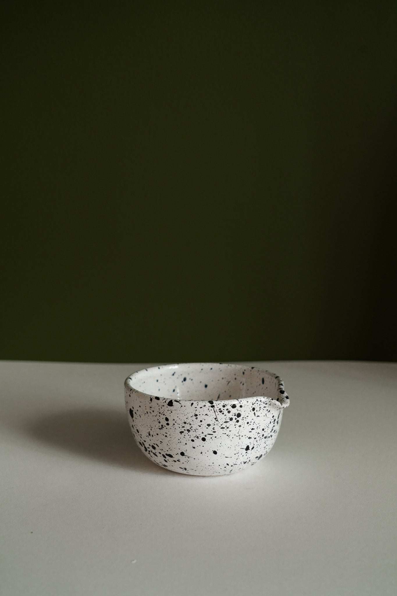 Set of deep stoneware mixing and serving bowls with pour spouts and speckled finish nesting together