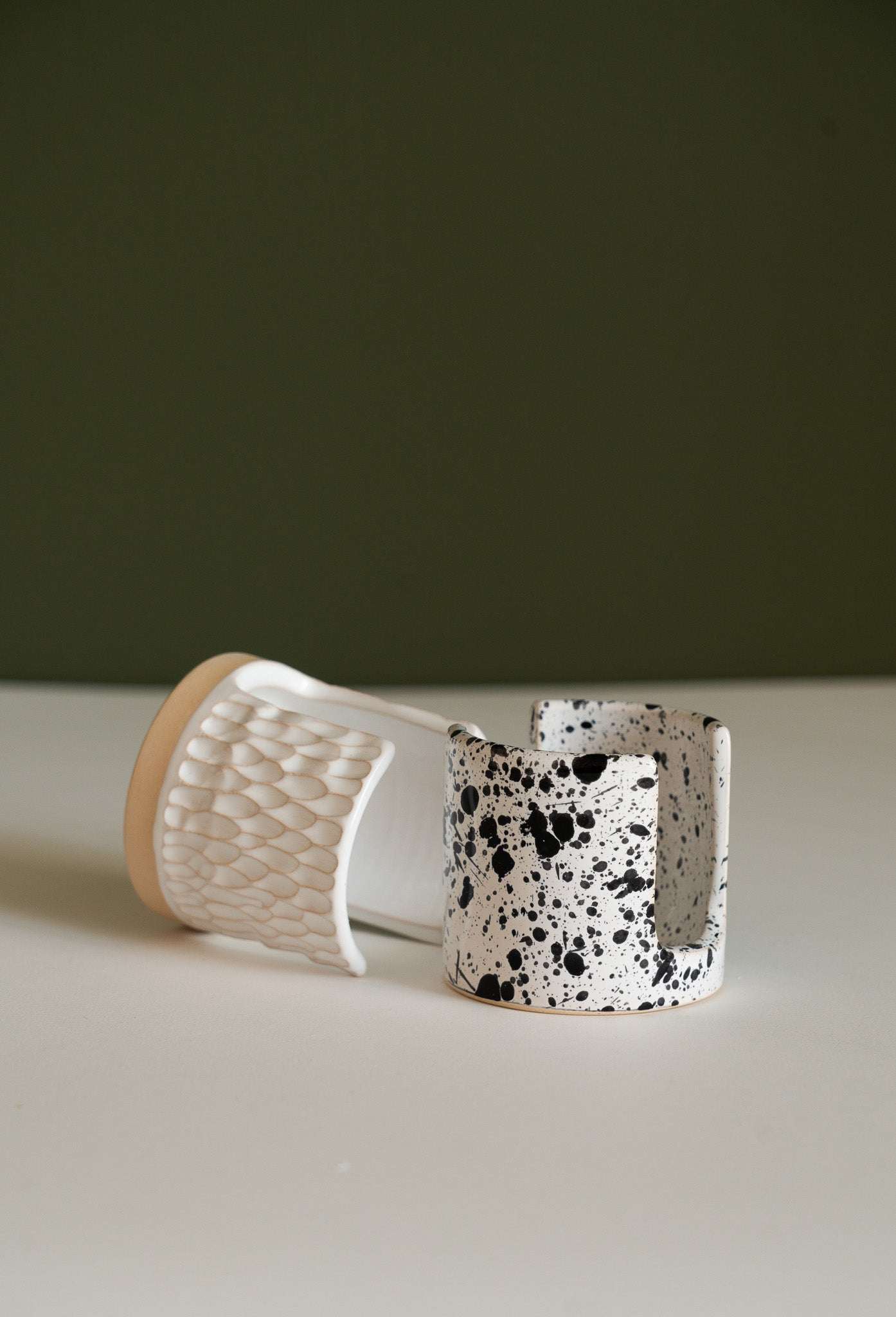 Handmade ceramic sponge holder in white glaze with carved scallop design for kitchen sink organization