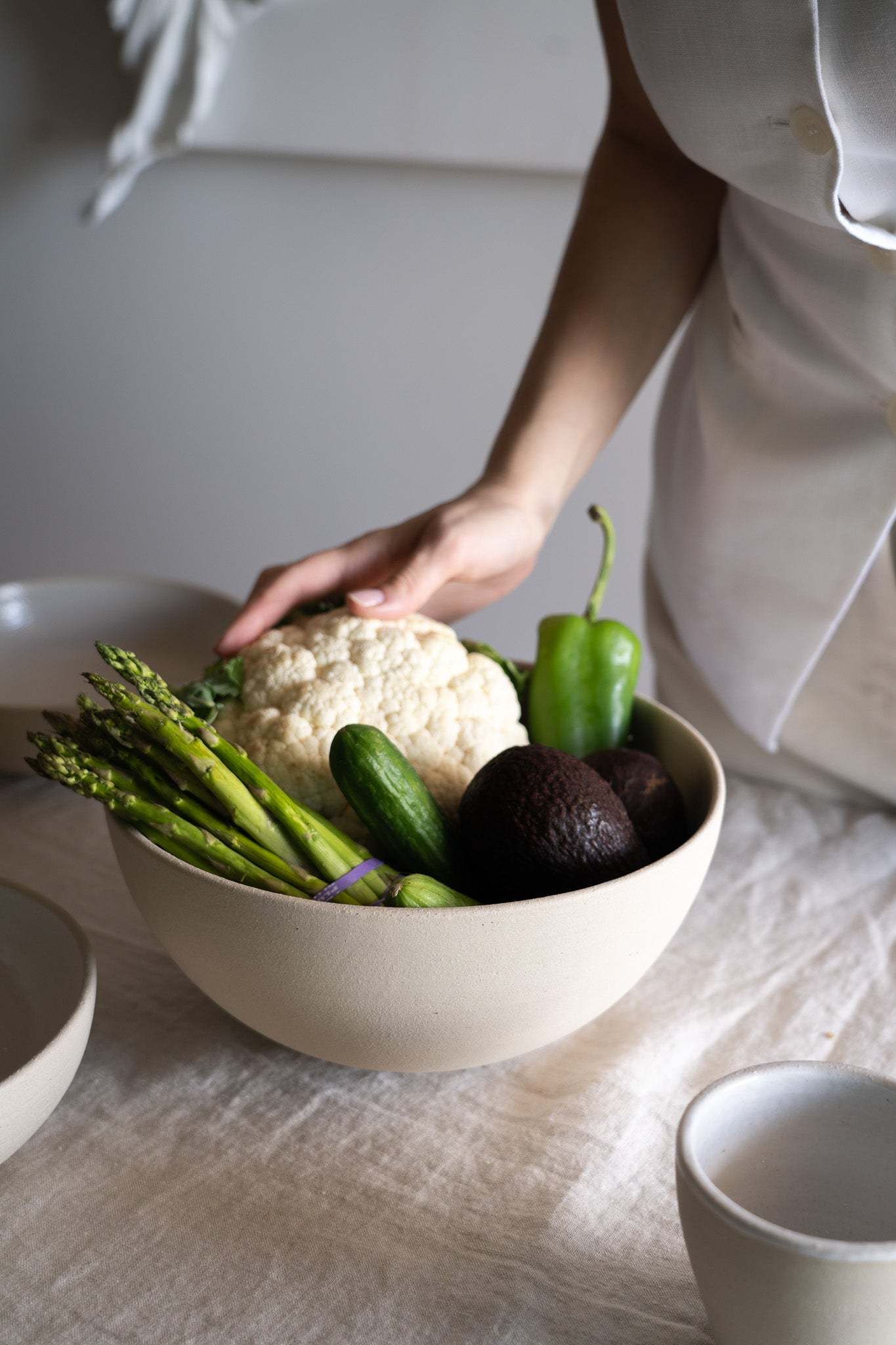 Handmade stoneware large fruit bowl with transparent glaze, showcasing natural pores and artisan craftsmanship, dishwasher and microwave safe.