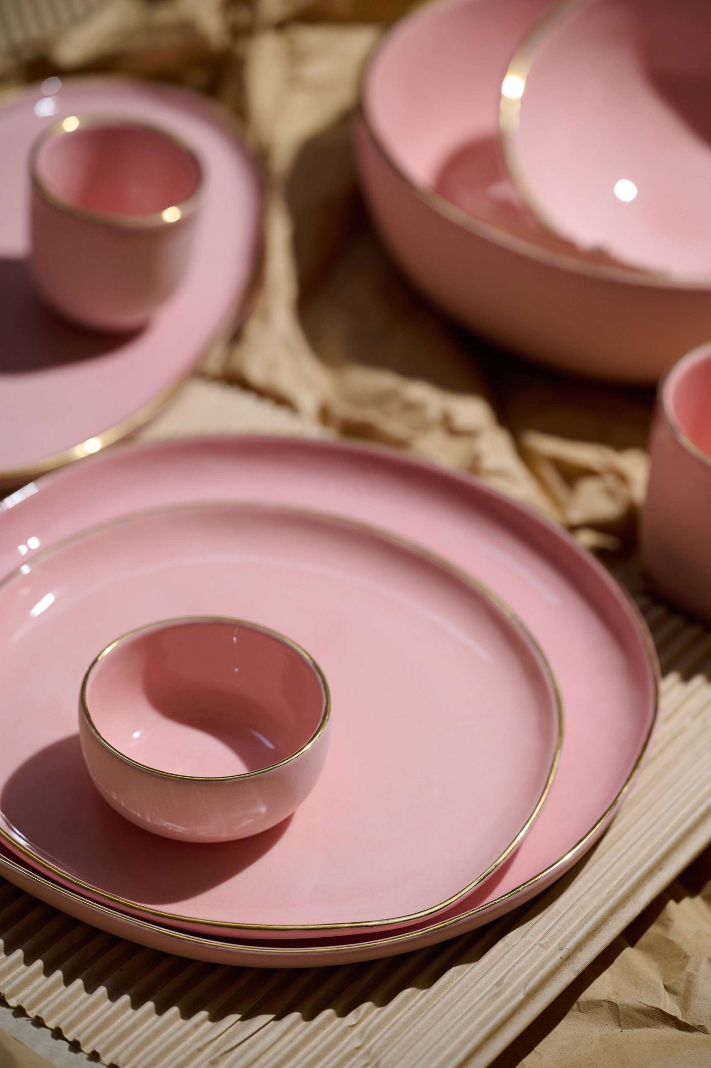 Handmade porcelain dinner plate with gold rim in powder pink color
