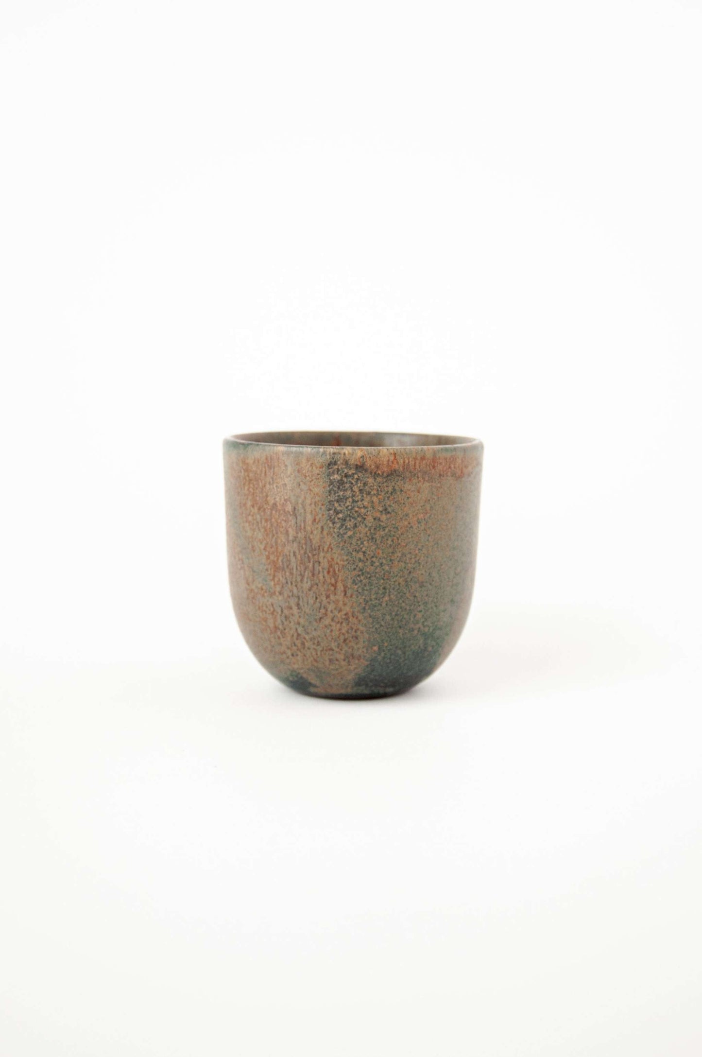 Rust stoneware espresso coffee cup with unique reactive glaze and organic edges