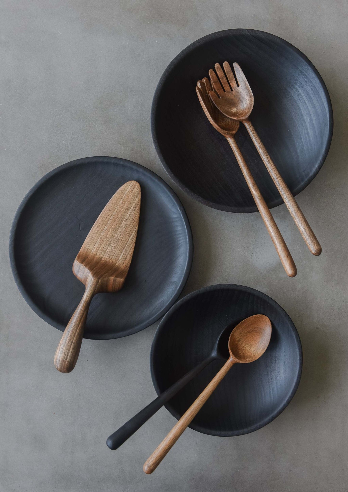 Hand-carved walnut wood spoon with straight handle showcasing unique grain and warm color