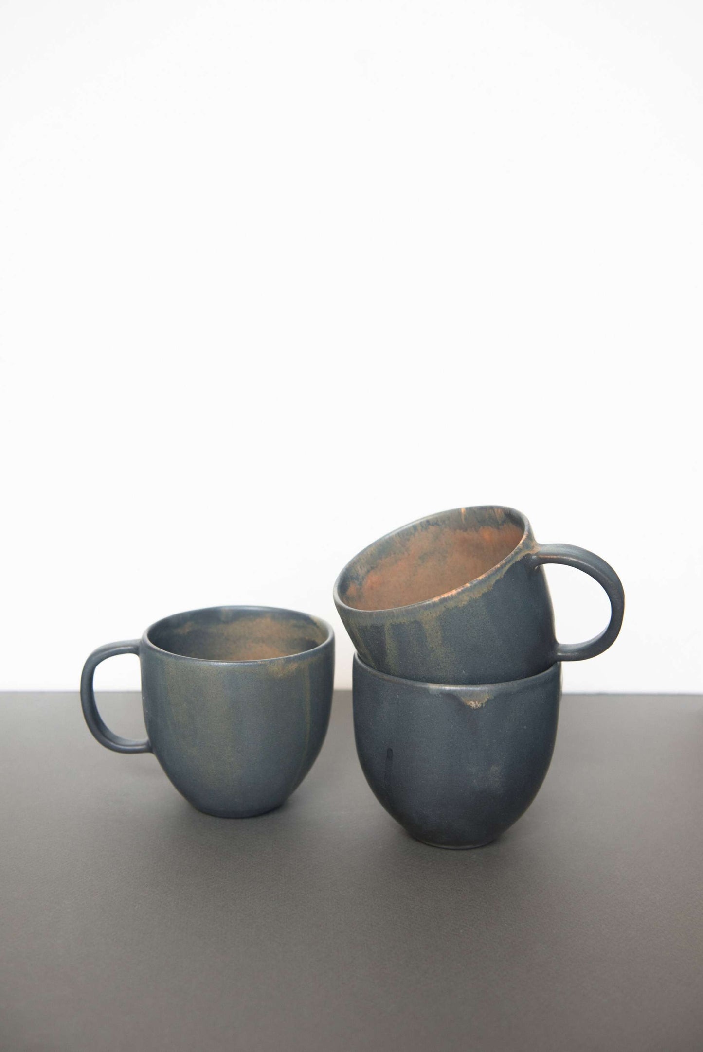 Rust stoneware coffee mug with organic edges and reactive glaze, handmade in Ukraine, dishwasher and microwave safe