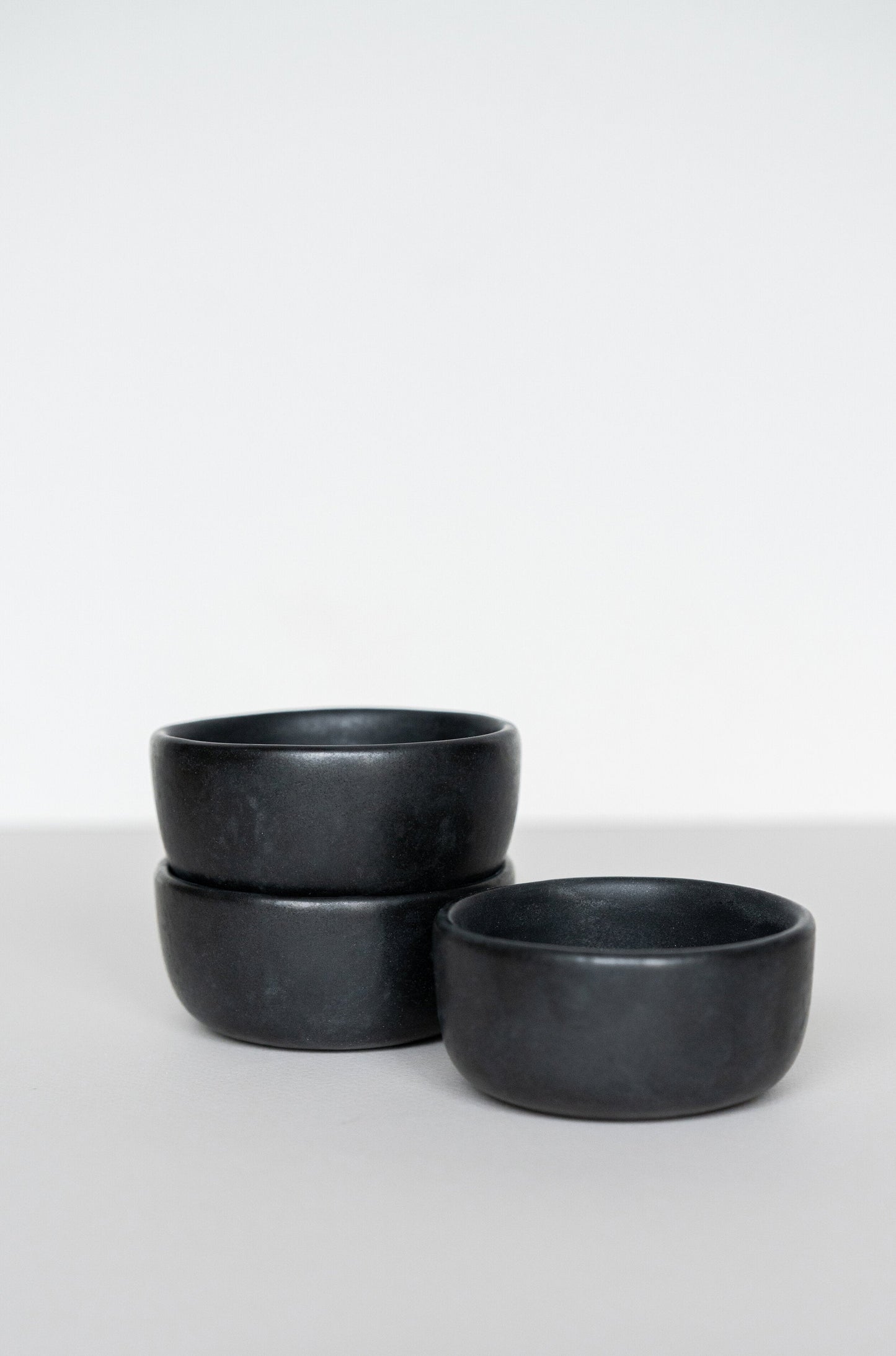 Black matte stoneware pinch bowl handmade in Ukraine, dishwasher and microwave safe, food-safe glaze, unique design