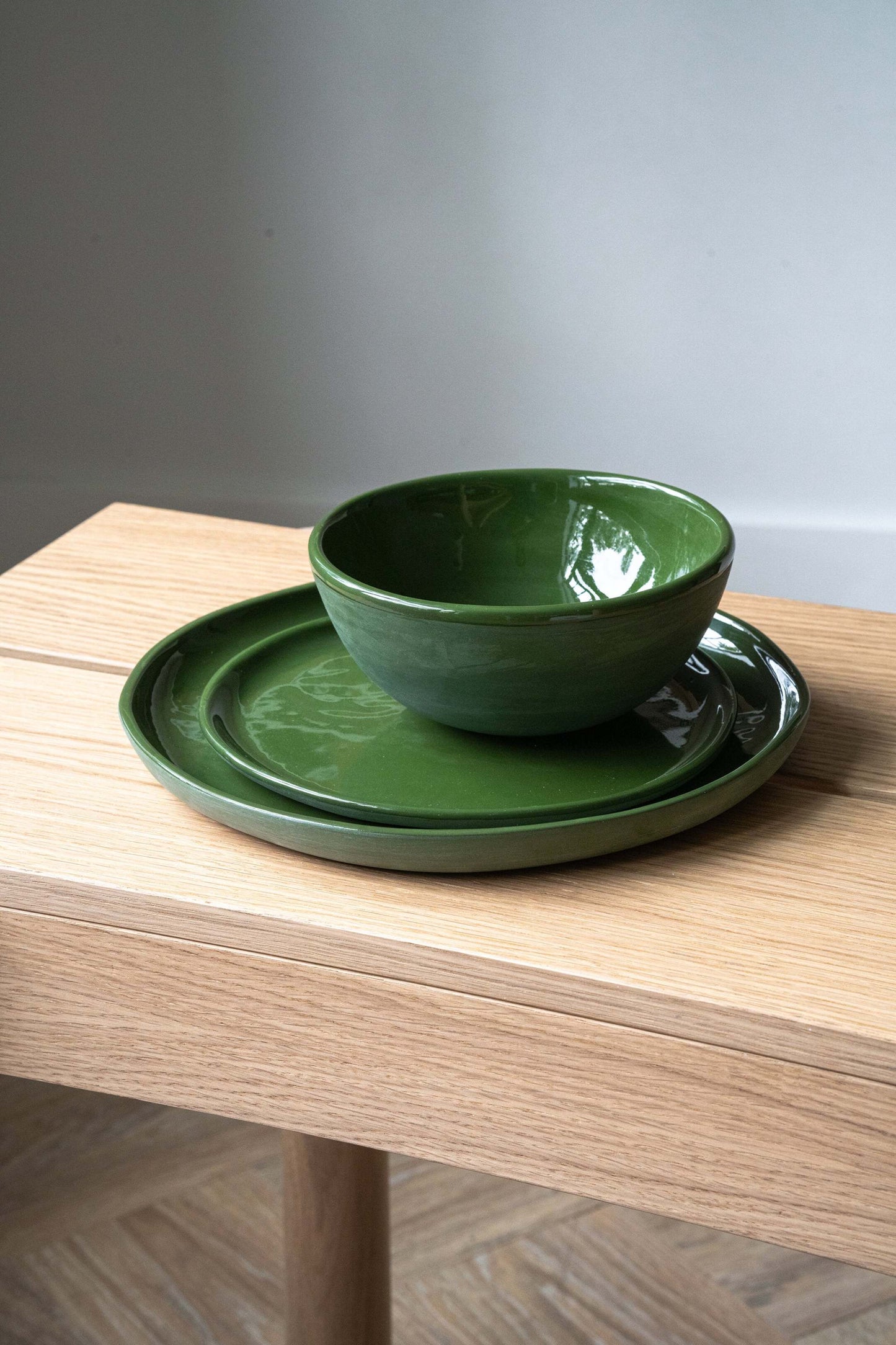 Set of handmade green porcelain dinner and salad plates with shiny glaze, made in Ukraine