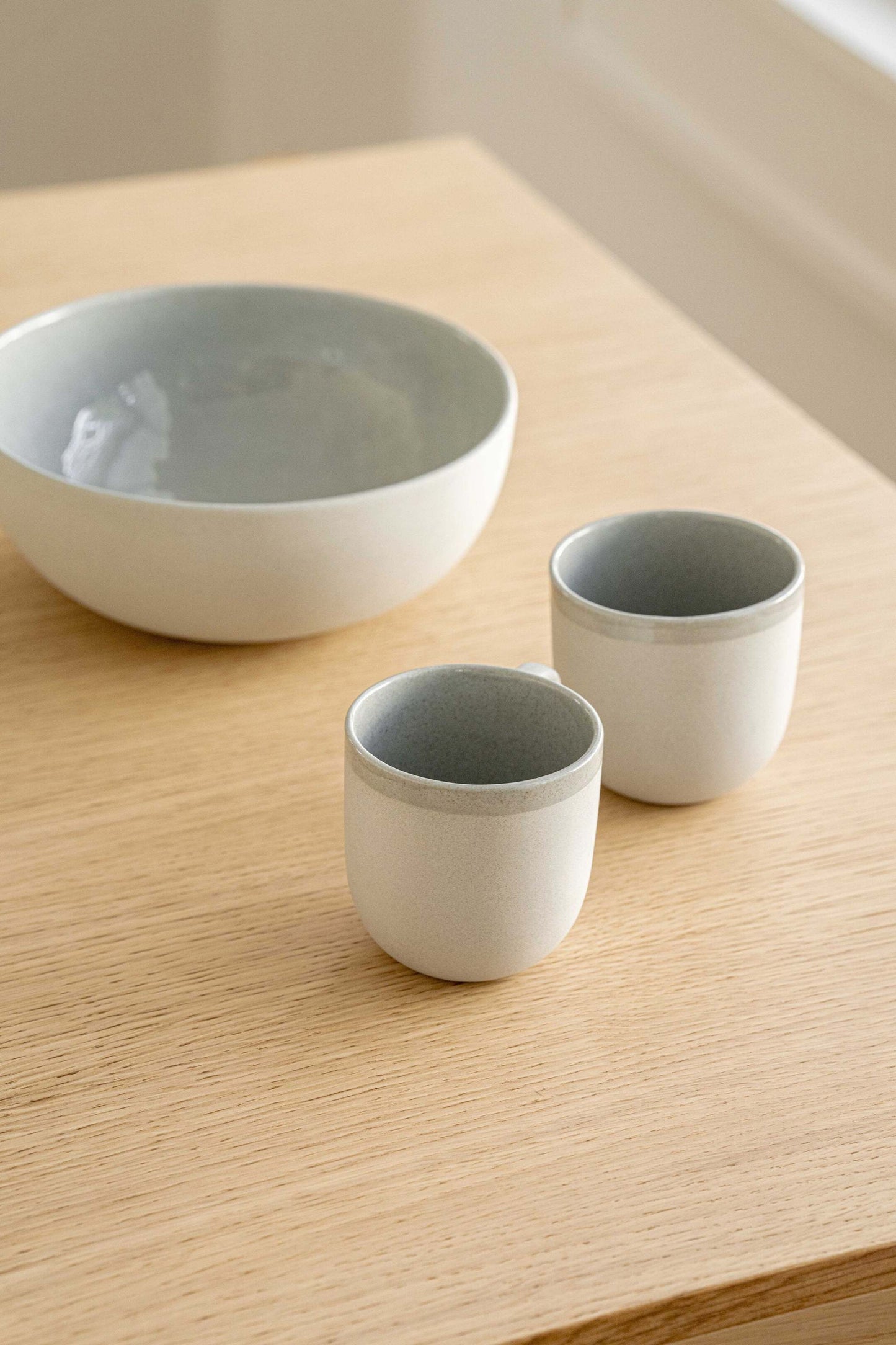Handmade porcelain coffee cup in gray sky color with shiny glaze and smooth polished finish
