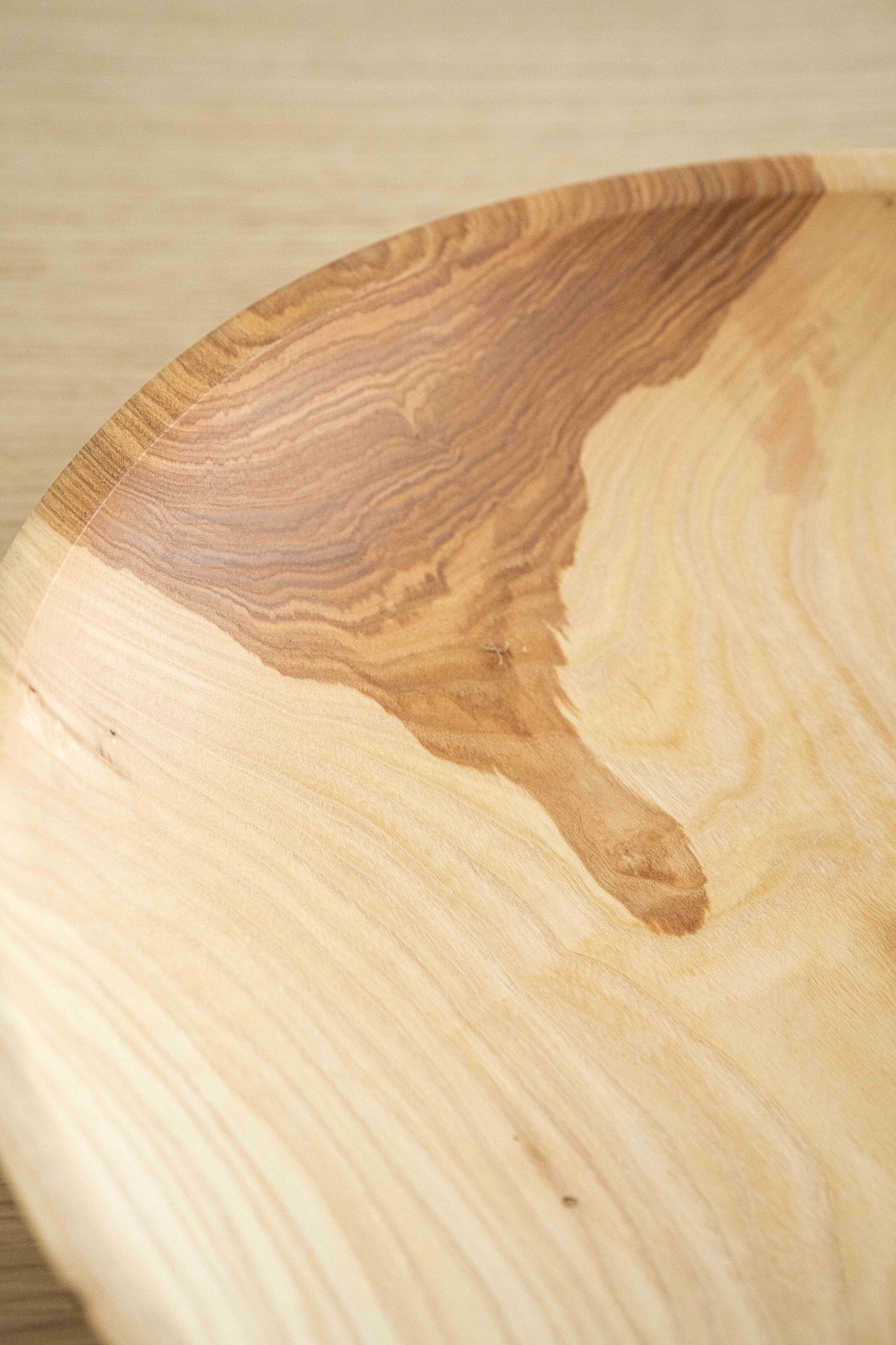 Hand-carved shallow ash wood fruit bowl with natural color gradient and 16-inch diameter