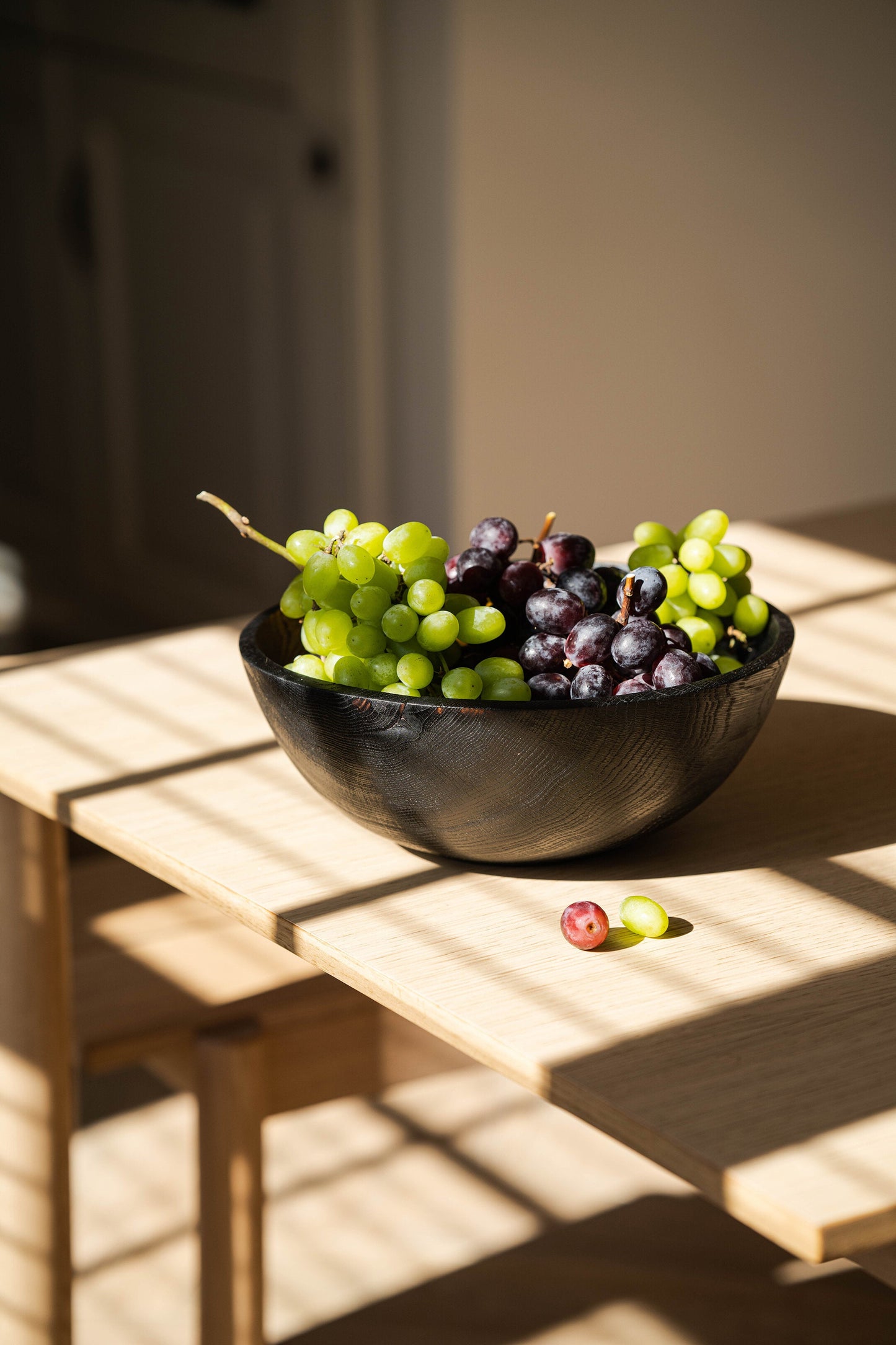 Hand-carved large charred ash wood bowl with food-safe finish, handmade in Ukraine, perfect for fruits and vegetables.