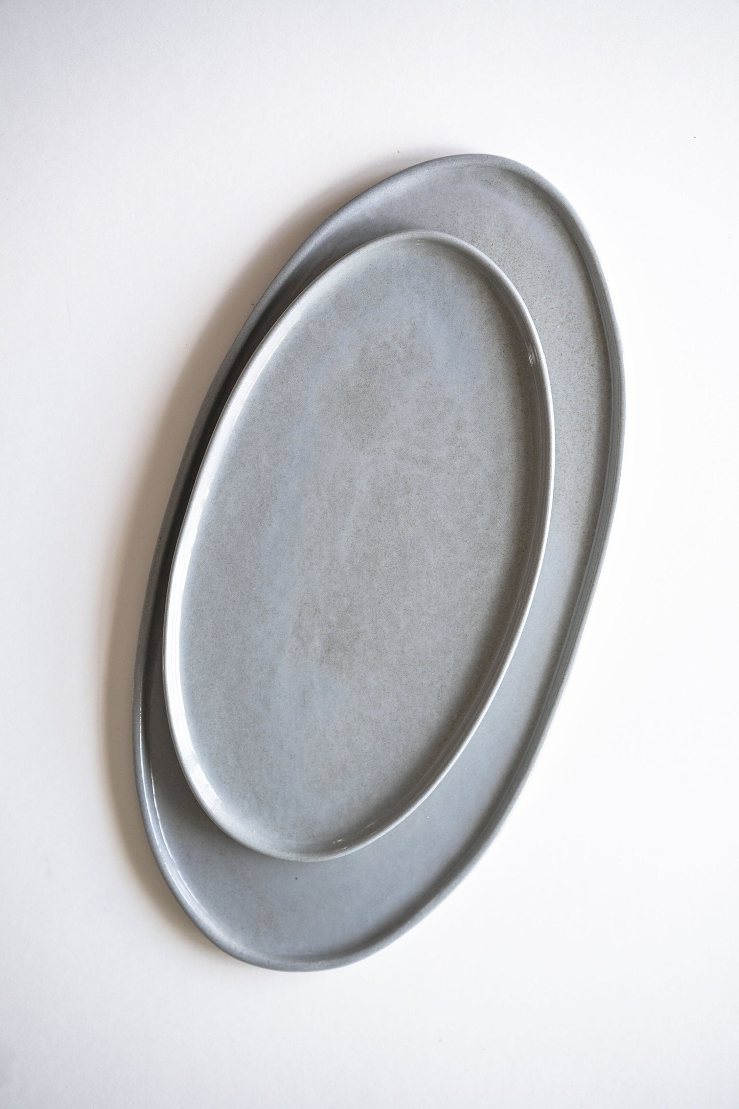 Handmade porcelain oval serving platter in gray sky color with organic edges