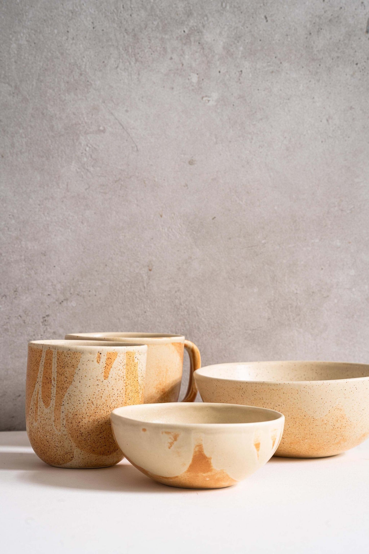 Beige matte stoneware bowl with reactive glaze and rust color strokes, handmade in Ukraine and food-safe.