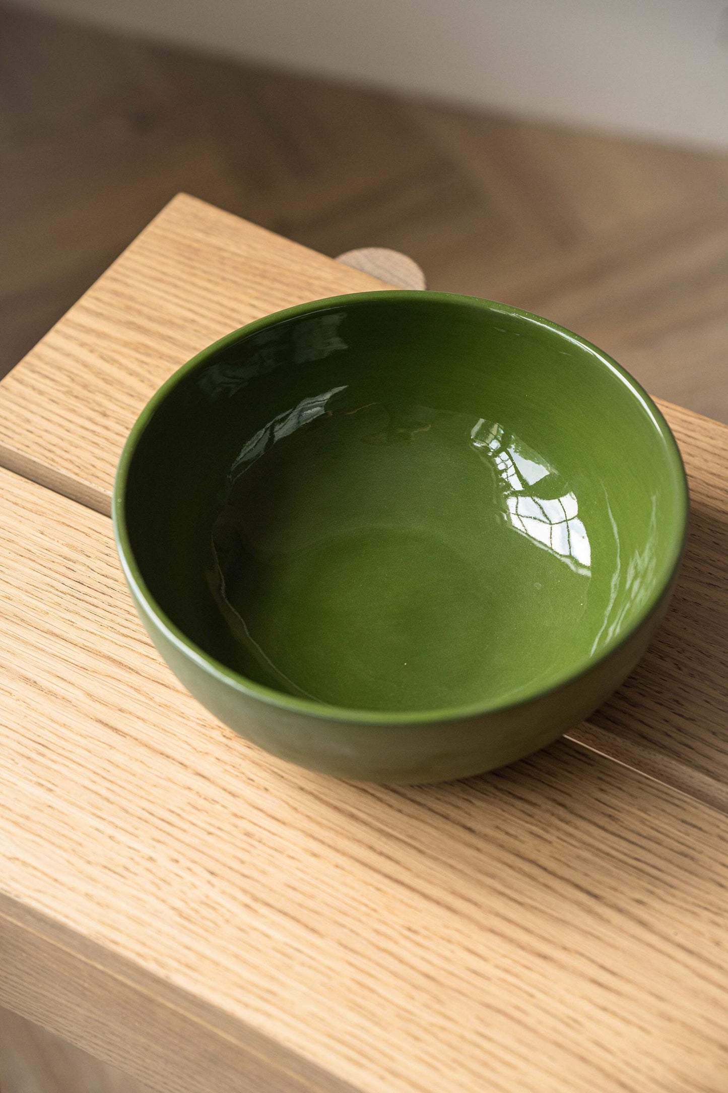Handmade green porcelain salad bowl with matte exterior and glossy interior, perfect for salads and soups