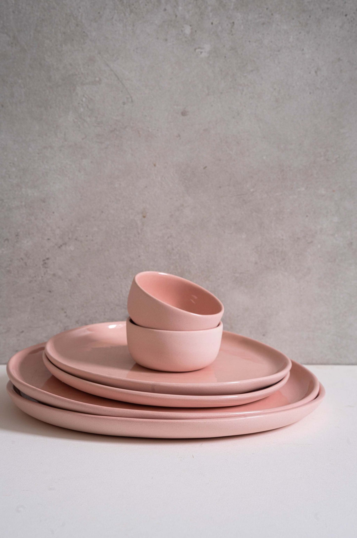 Handmade porcelain dinner plates set in powder pink with shiny glaze, including dinner and salad plates, dishwasher and microwave safe, made in Ukraine