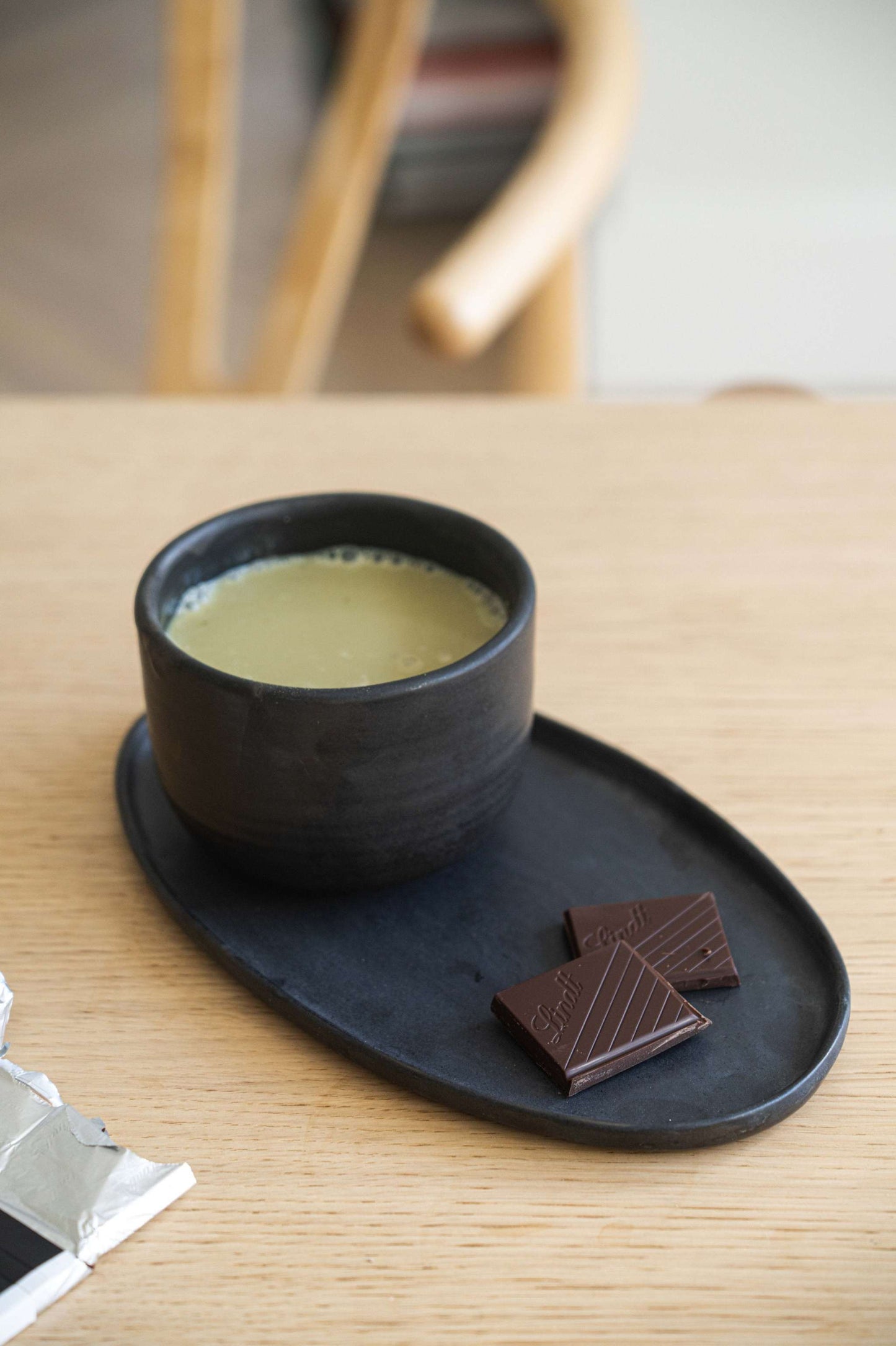 Minimalist handmade stoneware black matcha bowl with sharp vertical sides for proper whisking technique