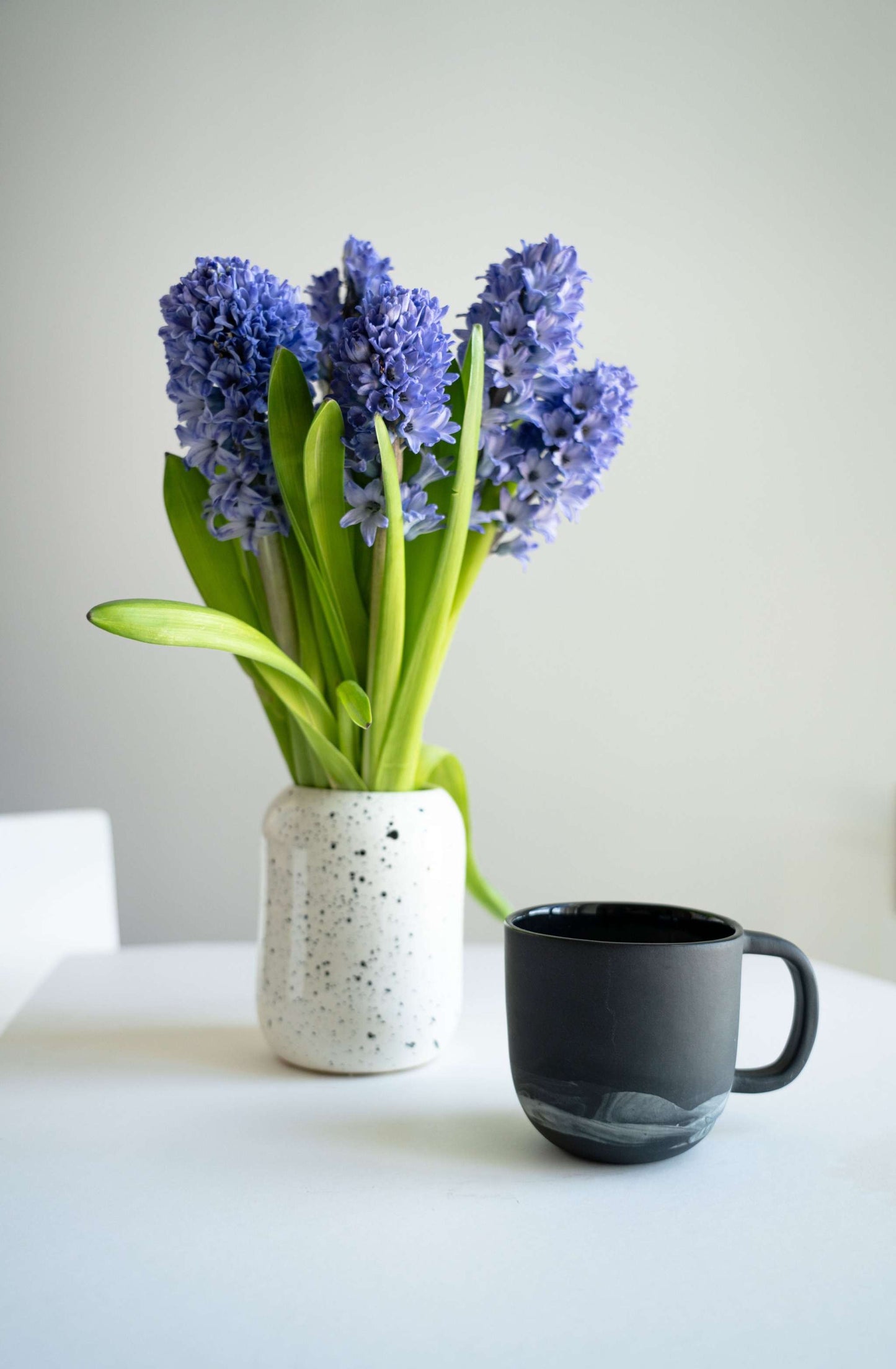 Handmade porcelain coffee mug with white clay swirls inspired by Iceland, black color, polished exterior, food-safe glaze, microwave and dishwasher safe, made in Ukraine