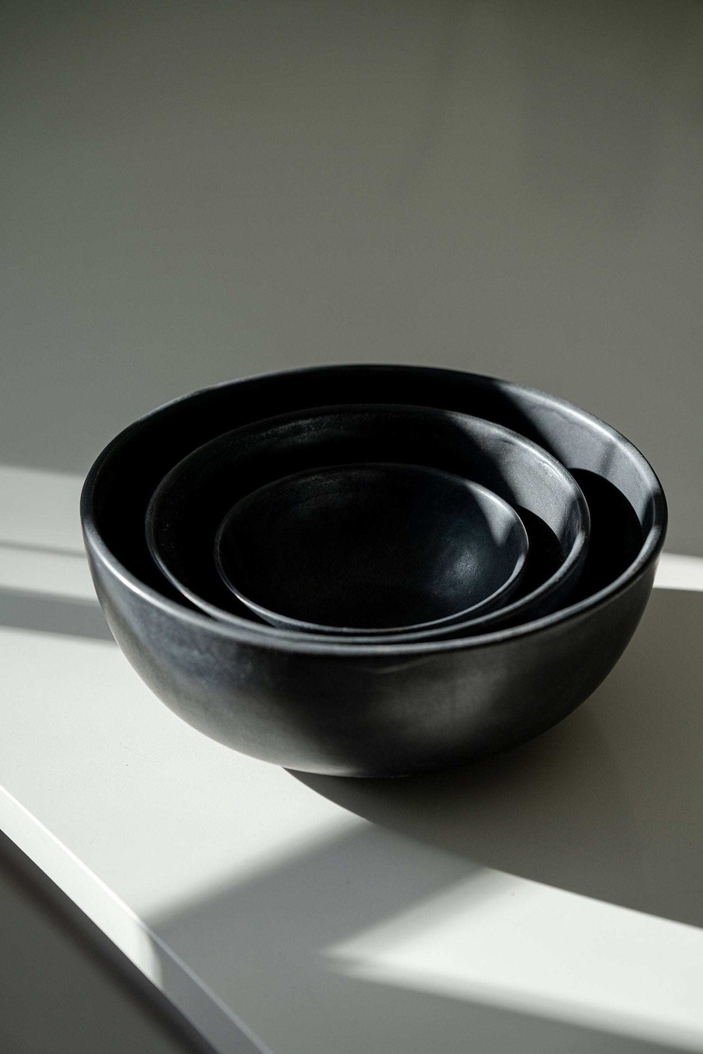Stoneware black matte handmade salad serving bowl with unique reactive glaze swirl