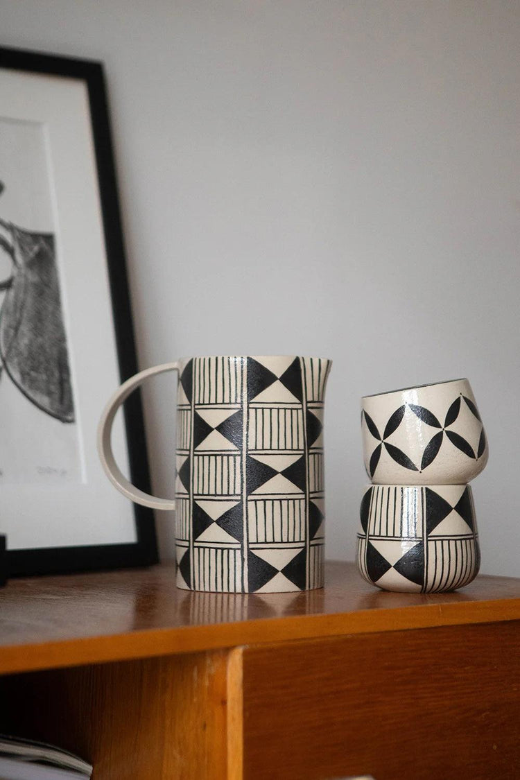 Handmade ceramic heritage pitcher with geometric black pattern on stoneware, 32 oz artisanal serving carafe