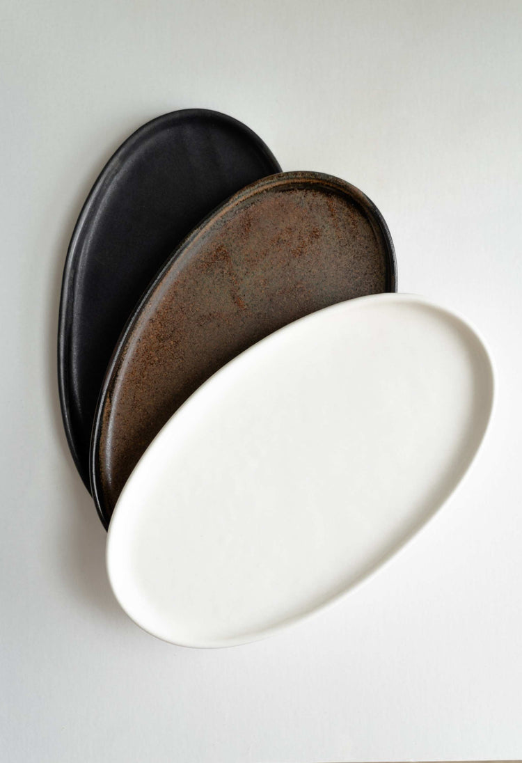 Rust matte stoneware serving platter with organic oval edges and unique reactive glaze, handmade in Ukraine