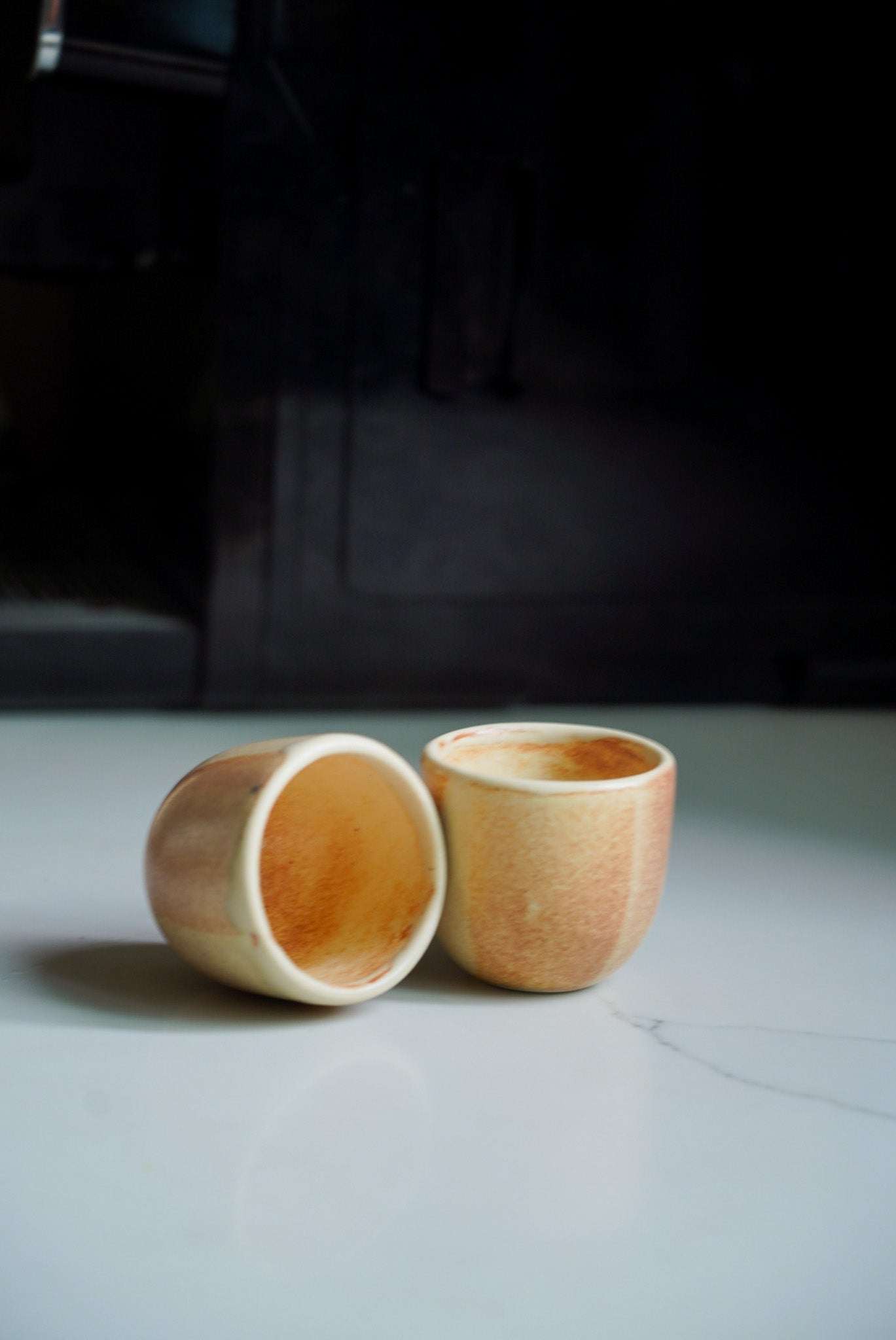 Beige stoneware espresso coffee cup with organic edges and reactive glaze, handmade in Ukraine