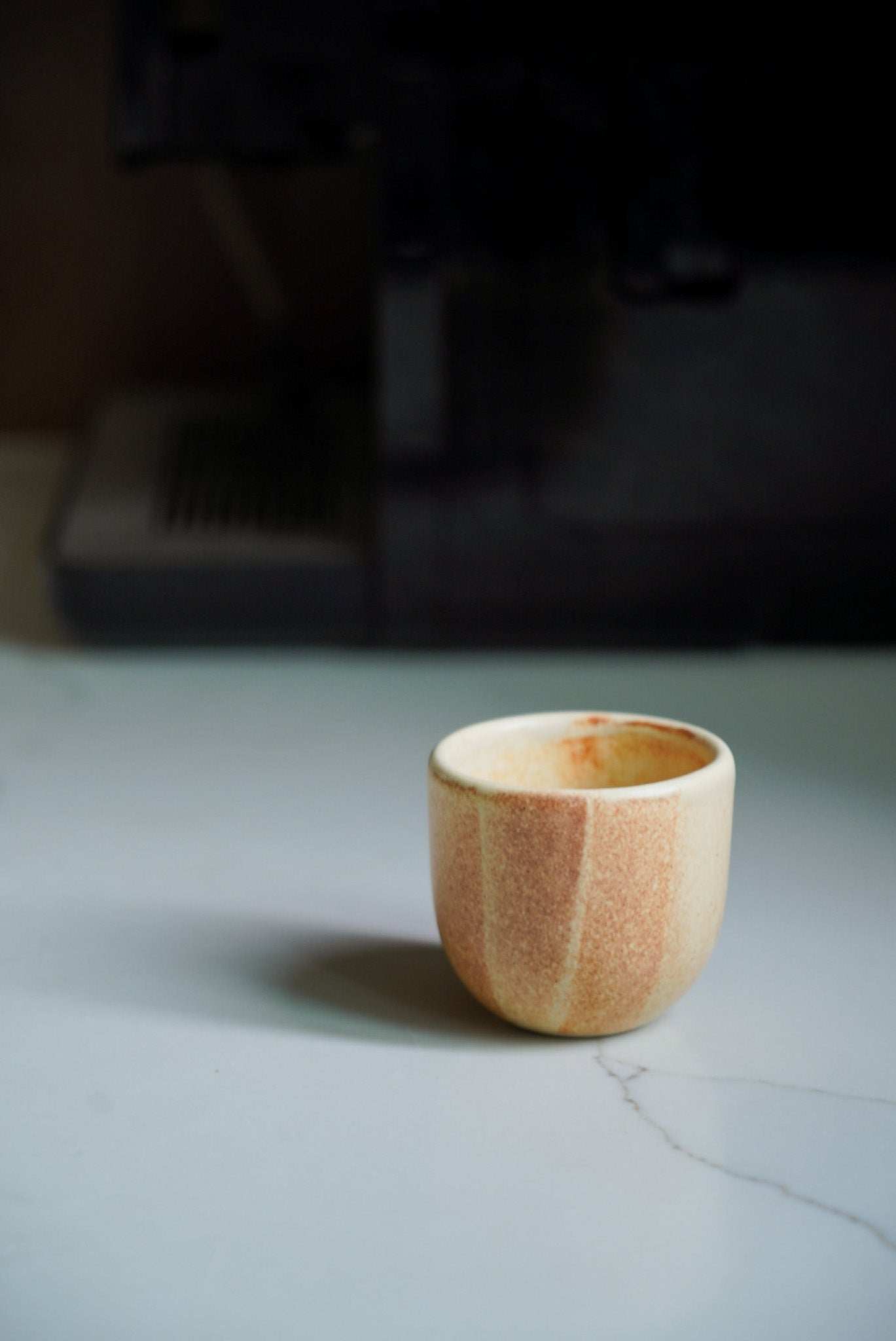 Beige stoneware espresso coffee cup with organic edges and reactive glaze, handmade in Ukraine